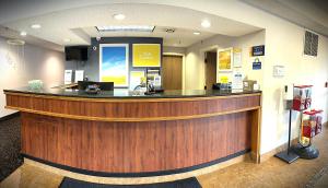 a lobby with a large wooden bar in a hospital at Days Inn by Wyndham Fargo - West Acres in Fargo +26 photos