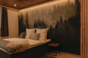 a bedroom with a bed with a painting on the wall at Chalet Ferienwohnung zwischen Berchtesgaden und Ramsau in Bischofswiesen