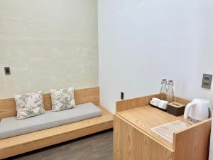 a room with a wooden bench with pillows on it at SOLEIL HOSTEL in Hue +28 photos