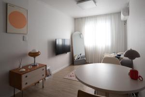 a living room with a table and a dining room at 서울역 2분거리, 클레어맨션 201 in Samgong