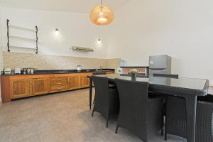 a kitchen with a table and some chairs in it at KyGunAya Villa in Gili Islands