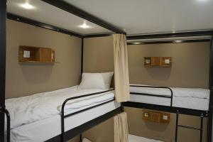 two bunk beds in a small room at New Hostel Braga in Bandung