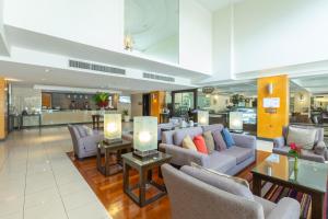 a lobby with couches and tables in a building at Kantary House Hotel, Bangkok in Bangkok +63 photos