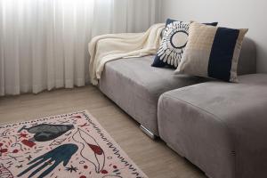a living room with a couch and a rug at 서울역 2분거리, 클레어맨션 201 in Samgong