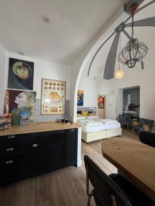 a living room with a bed and a dining table at Bibike in Catania