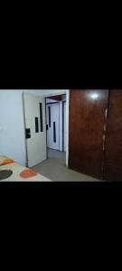 a room with two doors and a room with a bed at Bienvenidos Todos in Mexico City