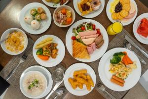 a bunch of plates of food on a table at Kantary House Hotel, Bangkok in Bangkok