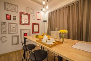 a dining room with a wooden table and two chairs at Collection O One Hotel in Ghaziabad +46 photos