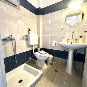 a bathroom with a toilet and a sink at Liberty Studio in Kallithea Halkidikis +19 photos