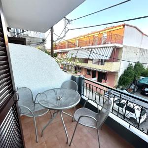 a balcony with a table and chairs on a balcony at Liberty Studio in Kallithea Halkidikis