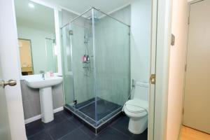 a bathroom with a shower and a toilet and a sink at O'Shea's Sukhumvit Bangkok in Klong Toi