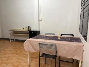 a table with two chairs and a table and a desk at Mama's Tree Homey Studio in Ban Klaeng Lang +15 photos