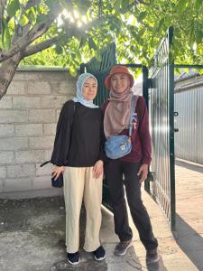 two women standing in front of a gate at 51 guest house in Bishkek