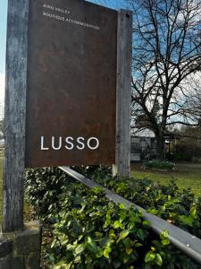 a sign for the university of vienna in a park at Lusso - Boutique Accommodation in Whitfield