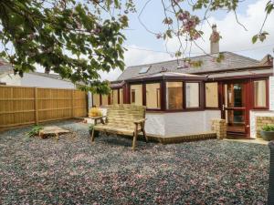 a house with a bench in the yard at Ty Taid in Gaerwen
