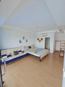 a large room with a bed and a couch at Top Views Retreat in Koh Rong Island