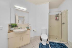 a bathroom with a toilet and a sink and a shower at Modern Metro by Host Solutions in Mawson Lakes +11 photos