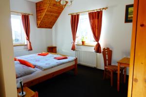 A bed or beds in a room at Penzion U Studánky