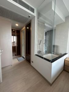 a bathroom with a large glass window and a tub at One9Five Asoke 可月租 in Ban Hui Yai Muk