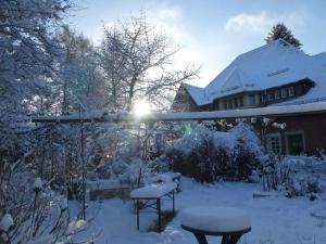 um quintal coberto de neve com uma casa em Villa-Hufeland em Berlim