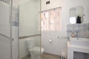 a bathroom with a toilet and a sink and a shower at 61 Lutie Katz in Yzerfontein +23 photos