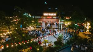 an overhead view of a party in front of a building at May Farm in Hương Hóa
