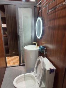 a bathroom with a toilet with the seat up at Nam Anh Homestay in Bảo Lộc