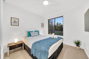 a bedroom with a bed and a window at Sub-Penthouse with Marina View by Host Solutions in Glenelg