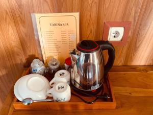 a tray with a tea kettle and other items on it at Dika Homestay in Sidemen