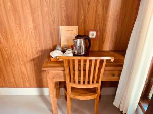 a wooden table with a tea kettle on top of it at Dika Homestay in Sidemen