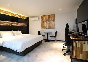 a bedroom with a bed and a desk with a computer at Incheon Illuwa Hotel in Incheon