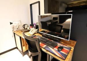 a desk with a computer monitor and a keyboard and mouse at Incheon Illuwa Hotel in Incheon