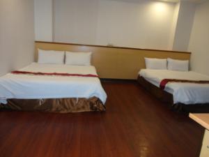 Postel nebo postele na pokoji v ubytování Yi Pin Yuan Hotel