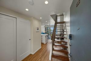 a spiral staircase in a room with a kitchen at Prime Oceanfront 2BR Loft - Unit C10 condo in Lahaina