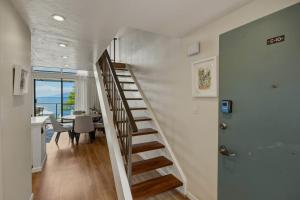 a staircase in a house with a dining room at Prime Oceanfront 2BR Loft - Unit C10 condo in Lahaina