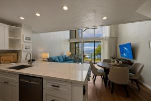 a kitchen with a table and a dining room at Prime Oceanfront 2BR Loft - Unit C10 condo in Lahaina +51 photos