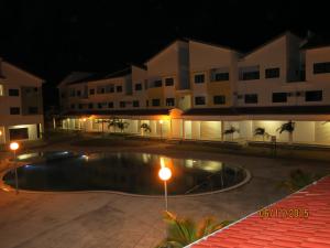a swimming pool in front of a building at night at Pangkor Lot 10 Vacation Studio in Pangkor