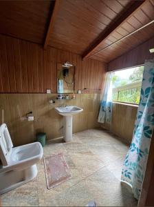 a bathroom with a toilet and a sink at Ella Antara Green Wood Cottage in Ella
