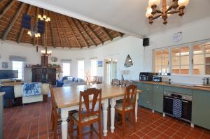 a large kitchen with a wooden table and chairs at 61 Lutie Katz in Yzerfontein