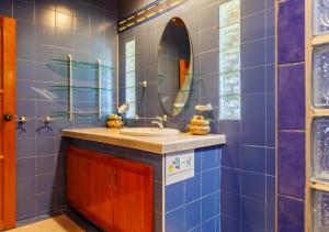 a bathroom with a sink and a mirror at Villa Anahata in Ban Tai