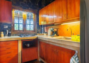 a kitchen with wooden cabinets and a sink at Villa Anahata in Ban Tai +35 photos