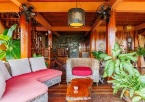 a living room with a couch and a chair at Villa Anahata in Ban Tai