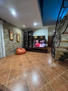 a living room with a tv and a floor at Casa Costeira in Redondela