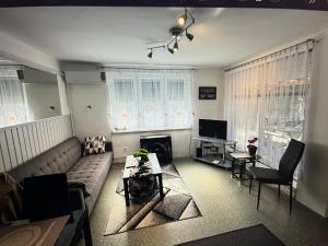 a living room with a couch and a table at Tomi Apartman in Velence