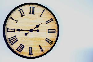 a large wooden clock with black roman numerals at Sable Shores in Batemans Bay