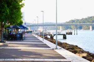 a pier next to a body of water with a bridge at Sable Shores in Batemans Bay +84 photos