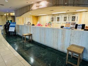 a food counter in a restaurant with two tables at Hotel Clio Court Hakata in Fukuoka