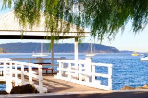 a white bench on a dock near the water at Sable Shores in Batemans Bay