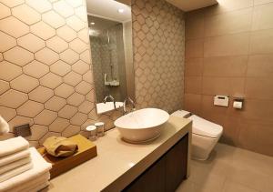 a bathroom with a sink and a toilet at Gangneung Grey Hotel in Gangneung