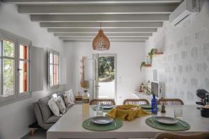 a living room with a table and chairs and a couch at Limonletto in Patmos